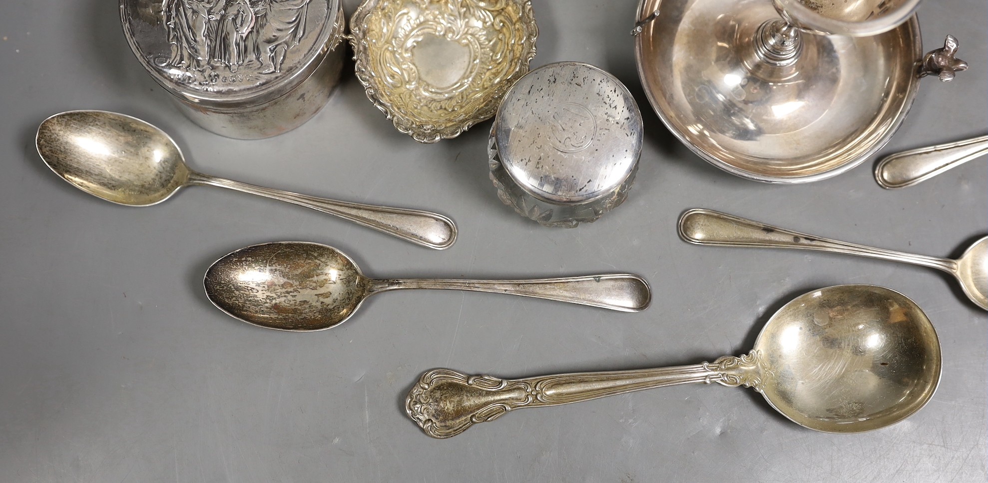 Miscellaneous silver ware including a mounted cigarette box, mounted posy vase, egg cup stand, late Victorian circular box and cover, repousse dish, eight sterling items including flatware and three other items.